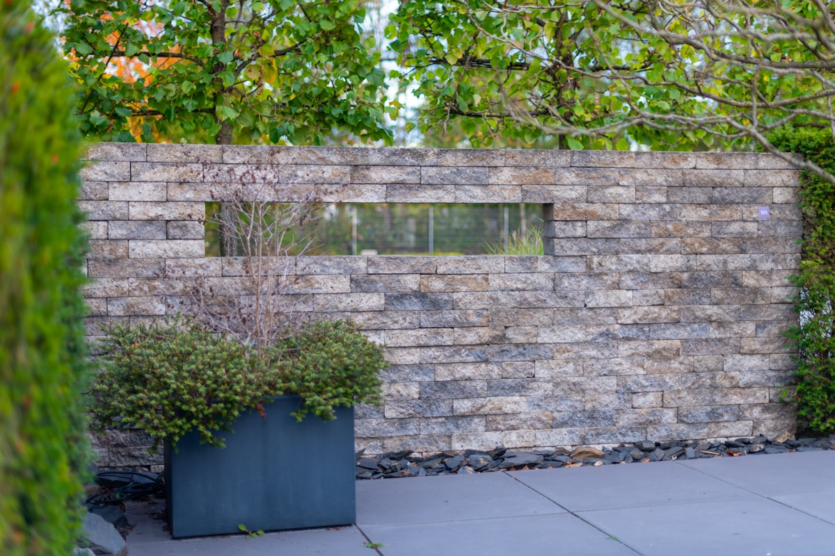 Engineered stone retaining wall integrated into landscaped grade.