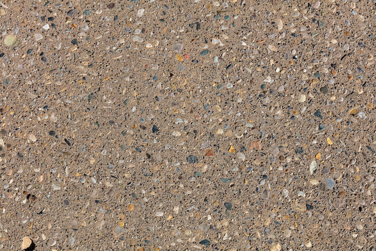 Sand-wash finished concrete driveway with exposed aggregate texture.