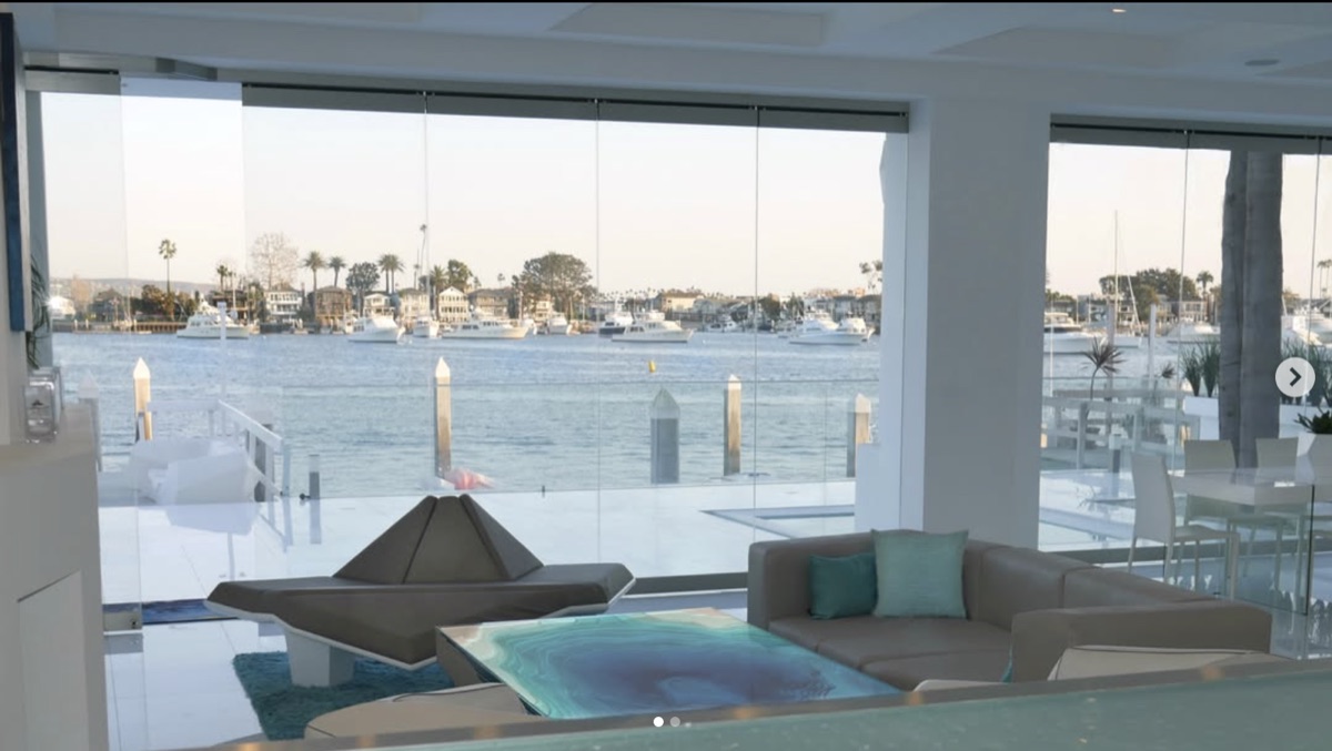 Floor-to-ceiling glass at a Newport Beach Varuna build framing the harbour at dusk.