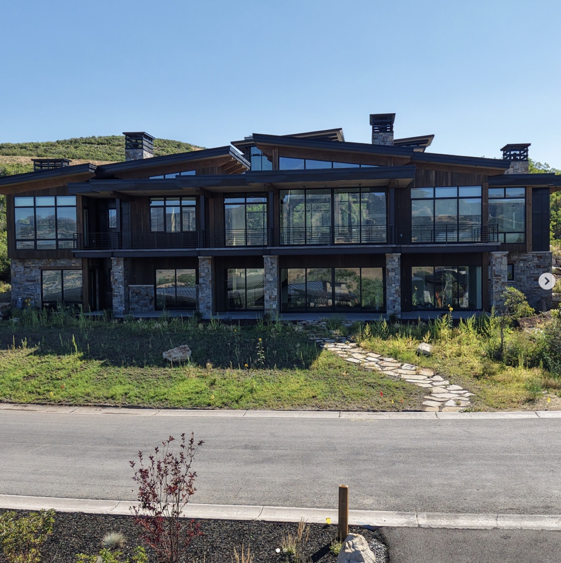 Wide hillside Varuna residence with deep timber siding and a long horizontal roofline.