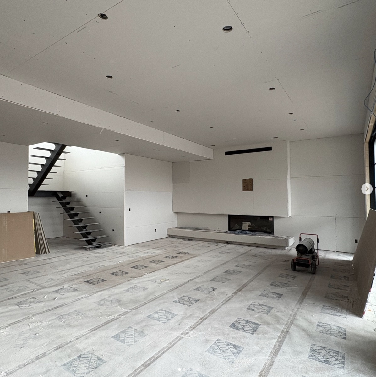 Interior of a Varuna build with floor protection in place during finishing, before flooring goes down over Warmboard.